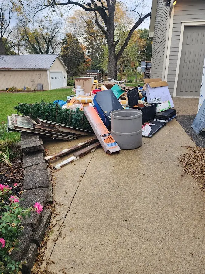 Dumpster being loaded with debris for 3 Yard Dumpster Rental in Springdale
